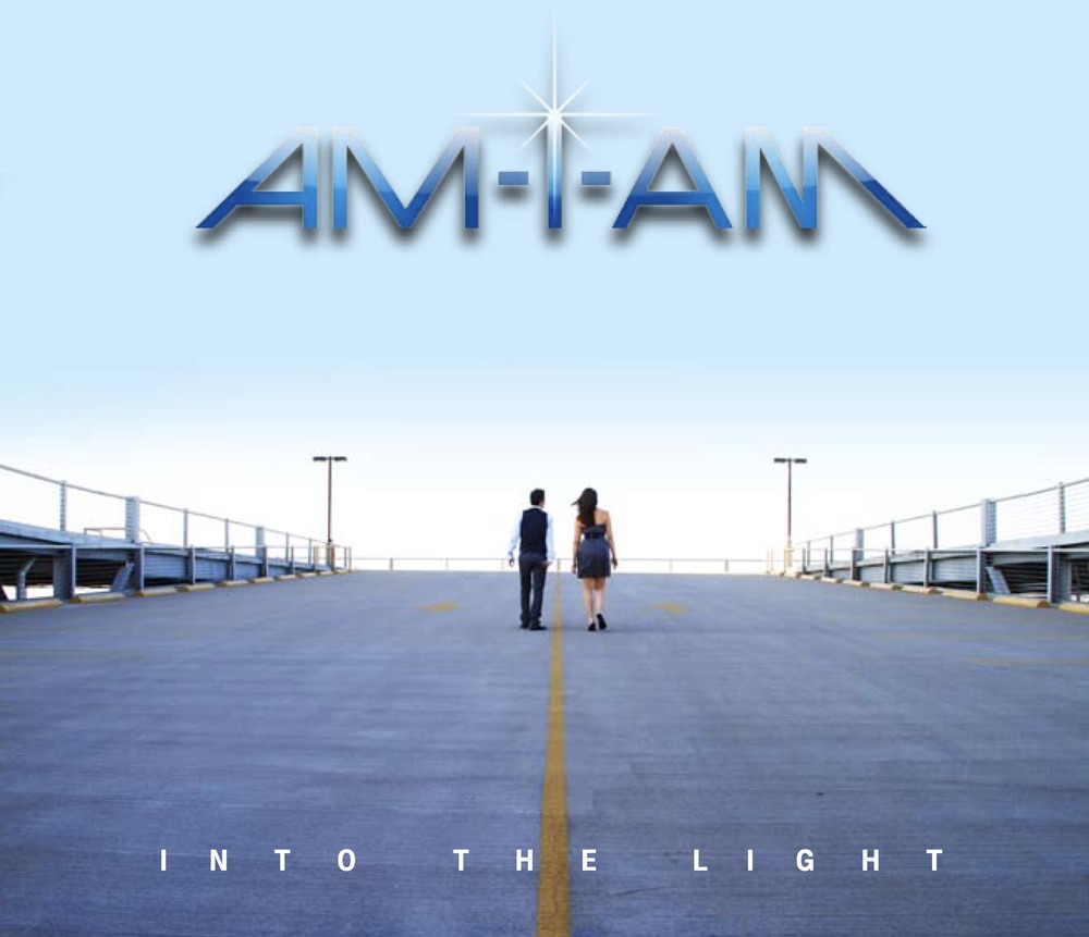 The Into the Light album cover: a couple walking away down an empty pier, a yellow center line running to the horizon, pale blue sky, the AM-I-AM wordmark above.
